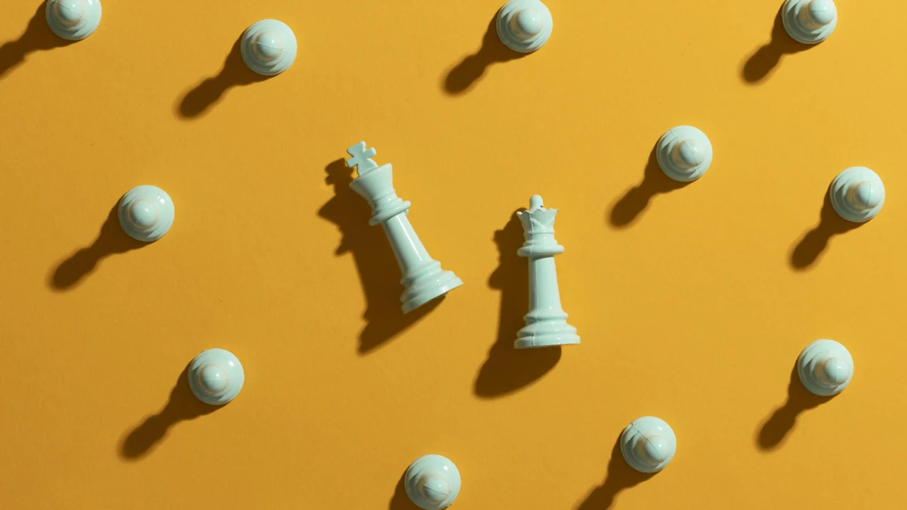 White chess pieces on a yellow background