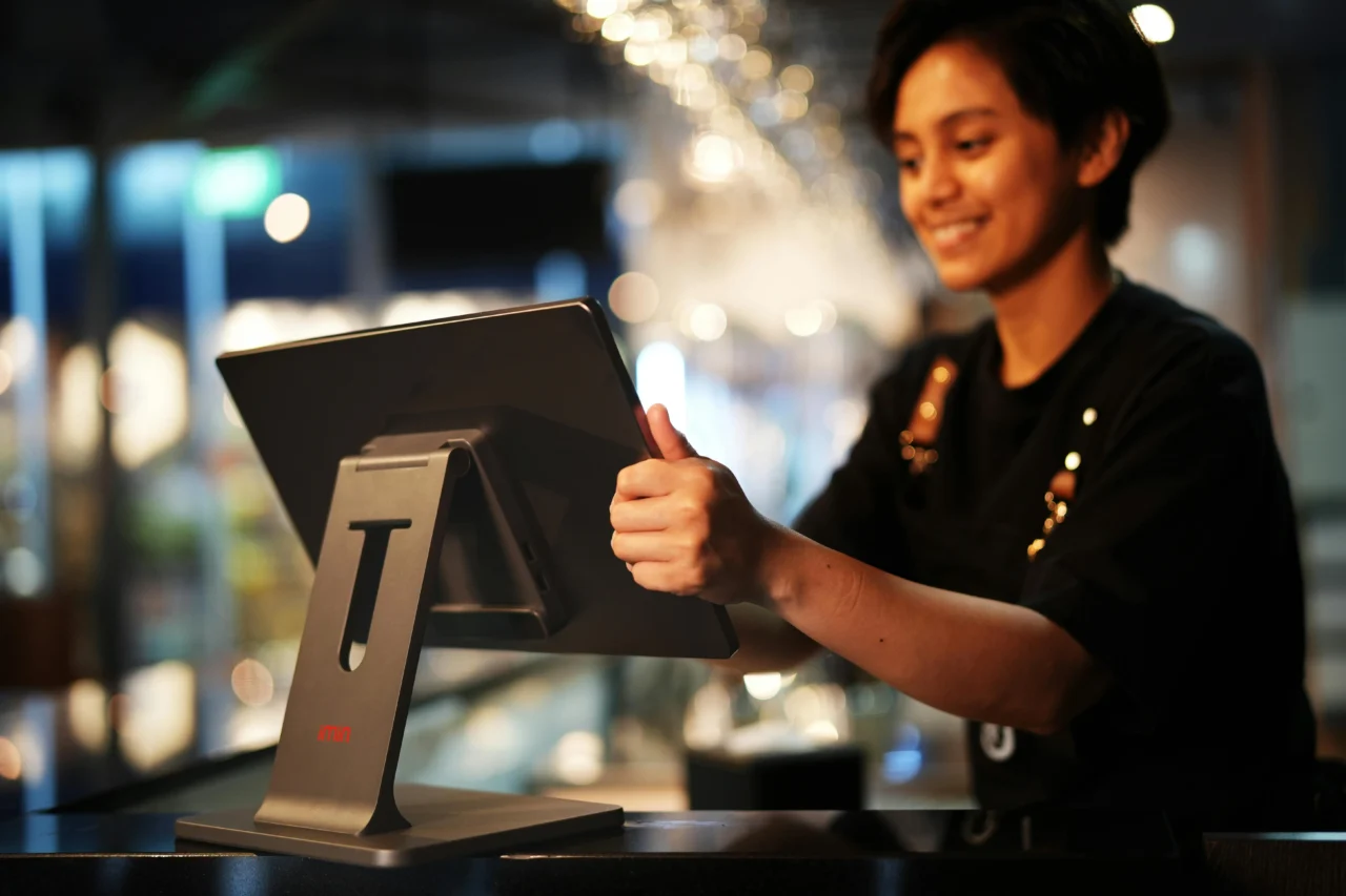 Examples of employee advocacy: Happy cashier operating cash register.